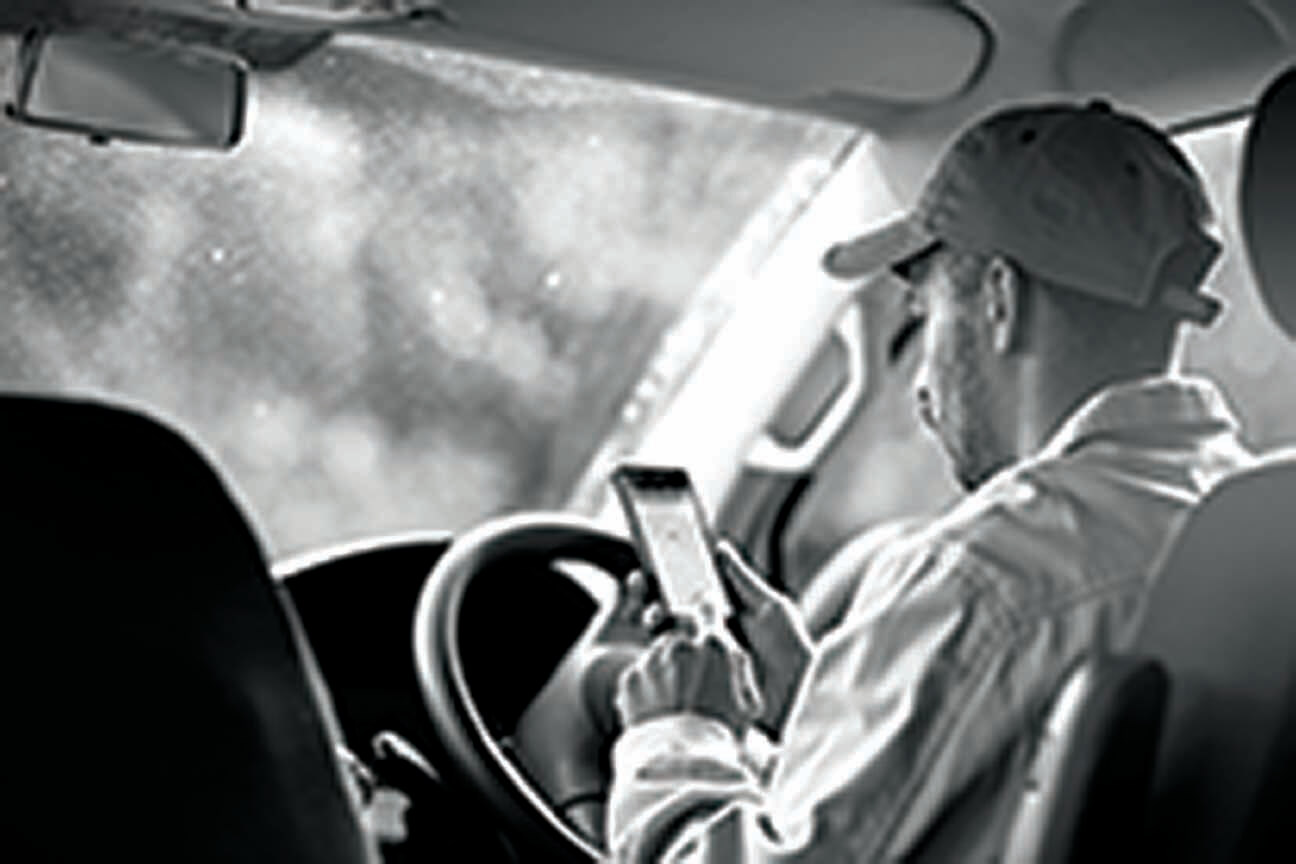 Driver looking at mobile app