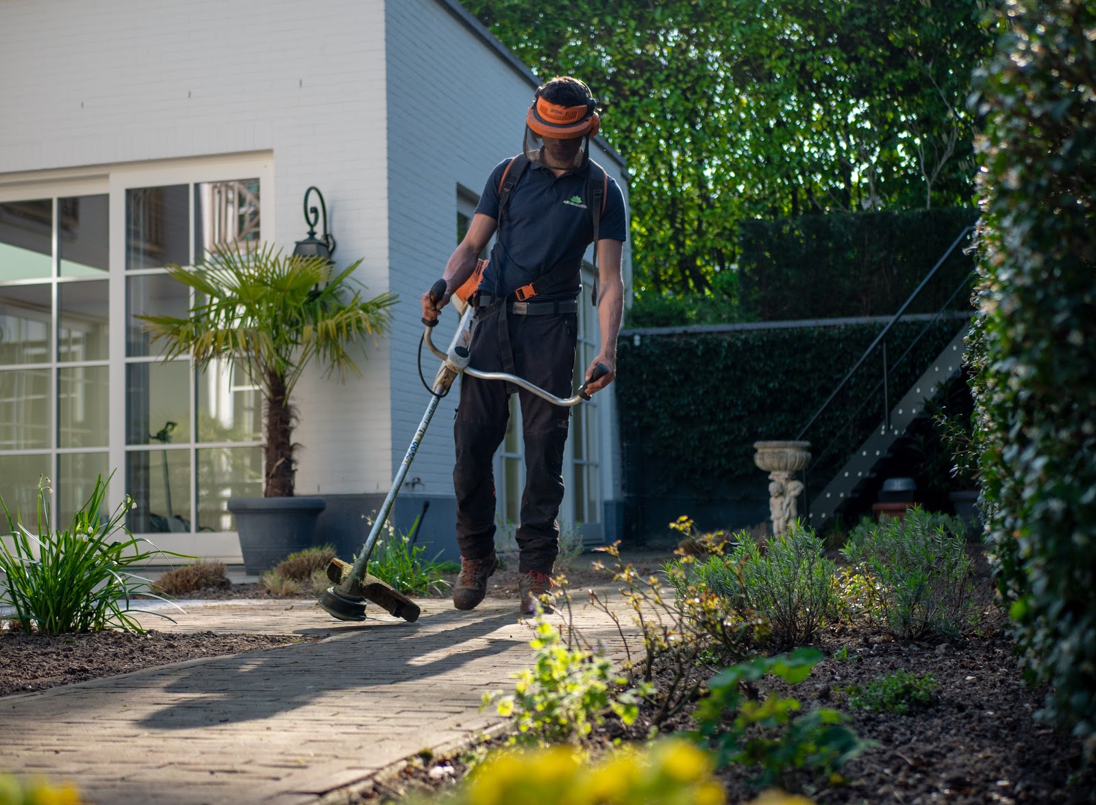 Landscaper trimming the edges of a garden