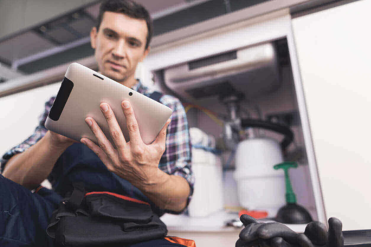 Technician checking his iPad during a field visit.